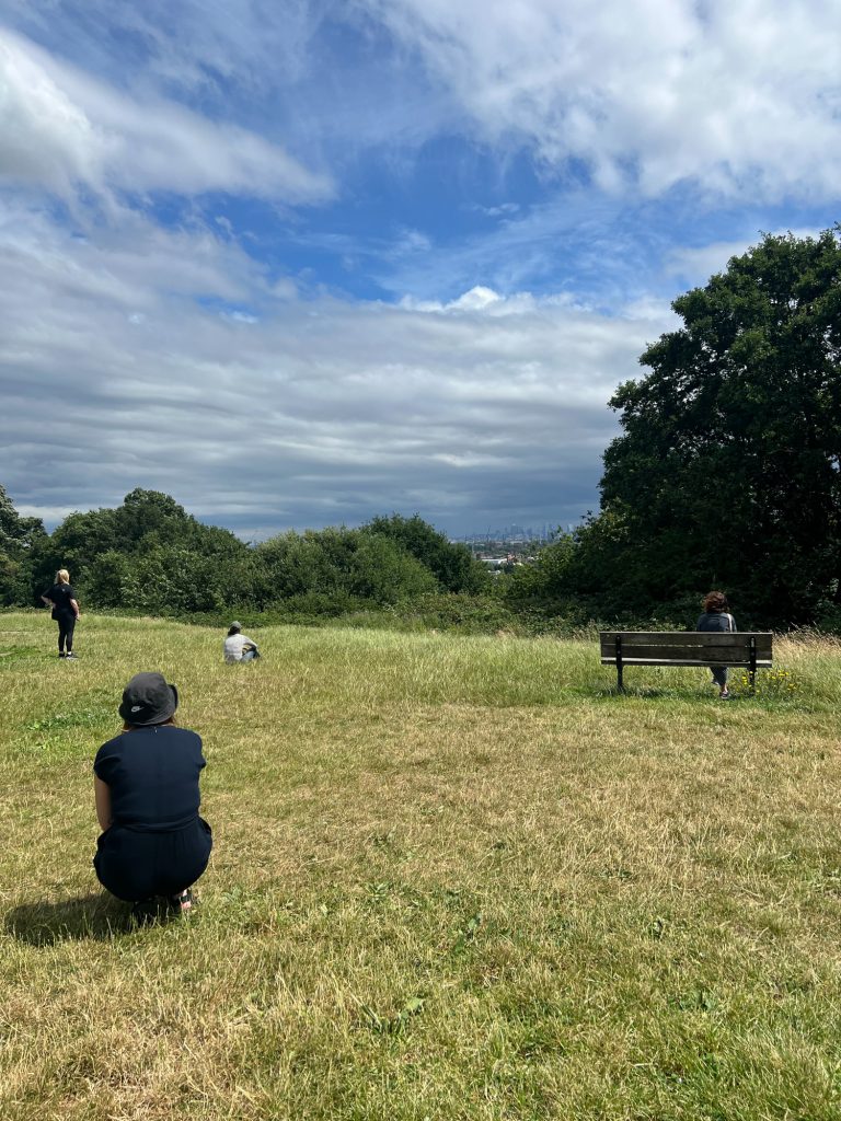 Participants overlooking the London skyline from Parliament Hill Viewpoing, taking a quiet moment to observe the landscape.